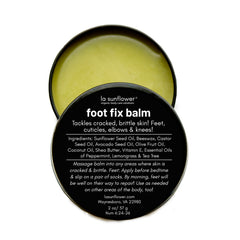 A open tin container of Foot Fix Balm with yellow colored balm visible inside, labeled for treating cracked, brittle skin and foot fungus.